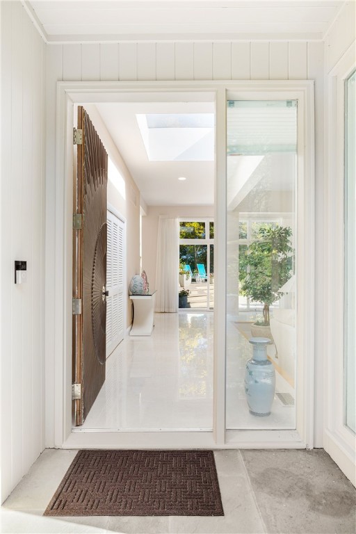 doorway to outside featuring a skylight