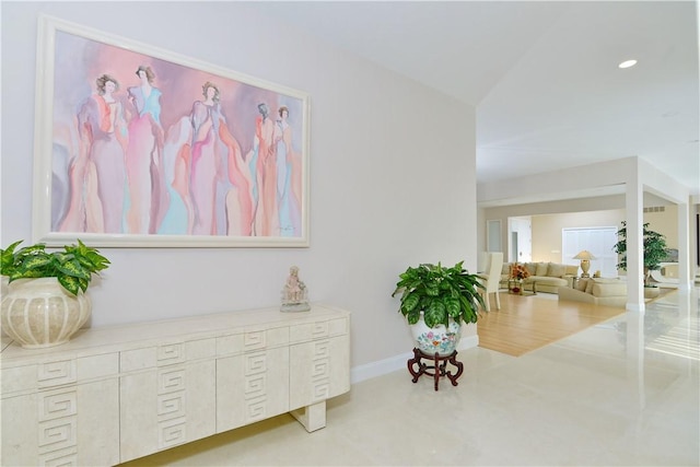 living area featuring baseboards and recessed lighting