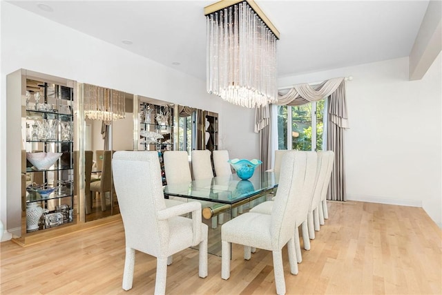dining area with a notable chandelier and wood finished floors