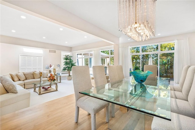 dining area featuring a notable chandelier, visible vents, recessed lighting, and wood finished floors