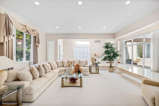 living area featuring visible vents and recessed lighting