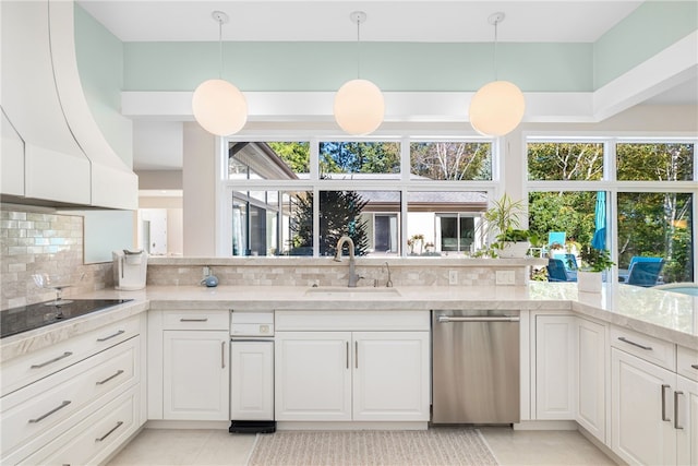 kitchen featuring a sink, tasteful backsplash, black electric stovetop, dishwasher, and white cabinets