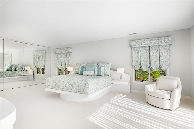 carpeted bedroom featuring baseboards