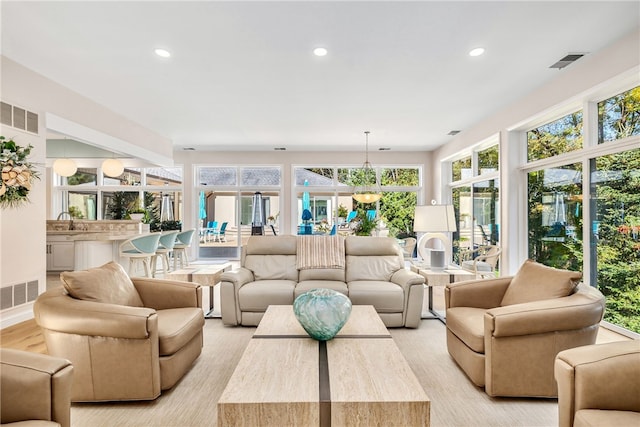 living area with visible vents and recessed lighting