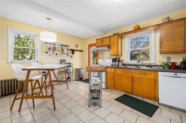 80 Wilcox Ave, Pawtucket, RI 02860 - kitchen featuring a sink, radiator, brown cabinetry, white appliances, and under cabinet range hood