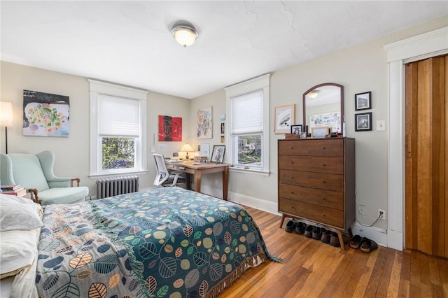 80 Wilcox Ave, Pawtucket, RI 02860 - bedroom featuring hardwood / wood-style flooring, baseboards, multiple windows, and radiator heating unit