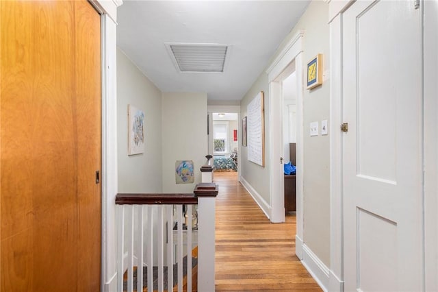 80 Wilcox Ave, Pawtucket, RI 02860 - hallway with baseboards, light wood finished floors, visible vents, and an upstairs landing