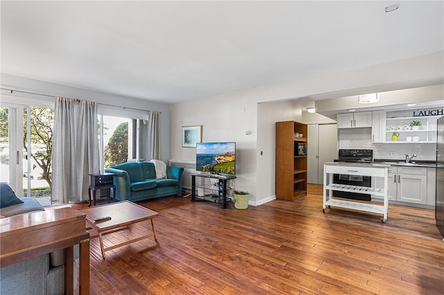 living area featuring baseboards and wood finished floors