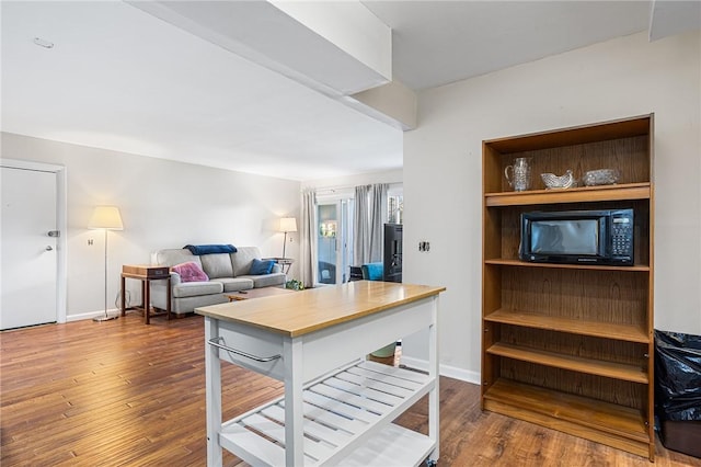living room with baseboards and wood finished floors