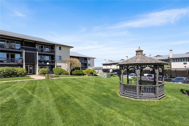view of home's community with a yard and a gazebo