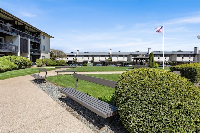 surrounding community featuring a yard and a residential view