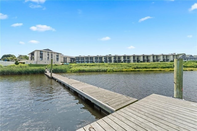 view of dock featuring a water view and a residential view
