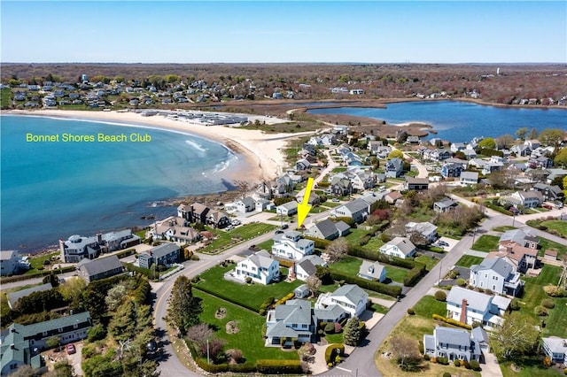 aerial view of property and surrounding area with a large body of water and nearby suburban area