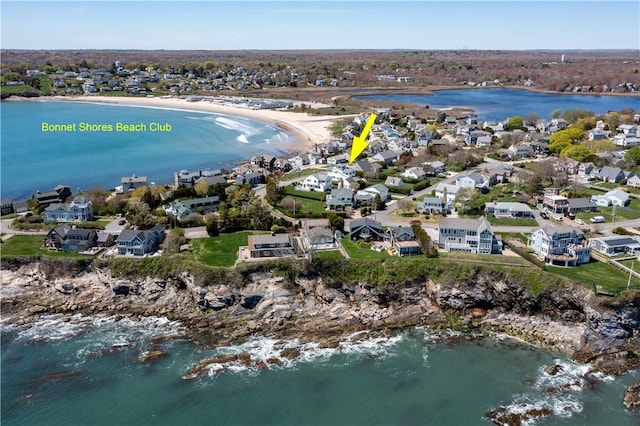 aerial overview of property's location with a nearby body of water and nearby suburban area