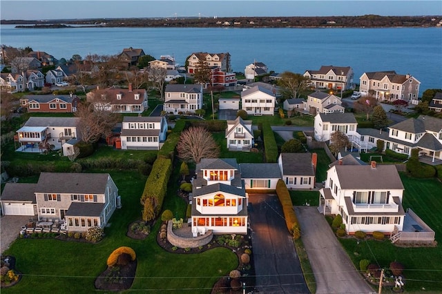 aerial perspective of suburban area featuring a nearby body of water