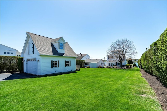 view of home's exterior with a garage, driveway, a lawn, and roof with shingles