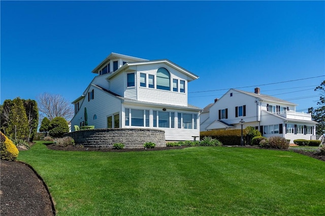 back of property featuring a lawn