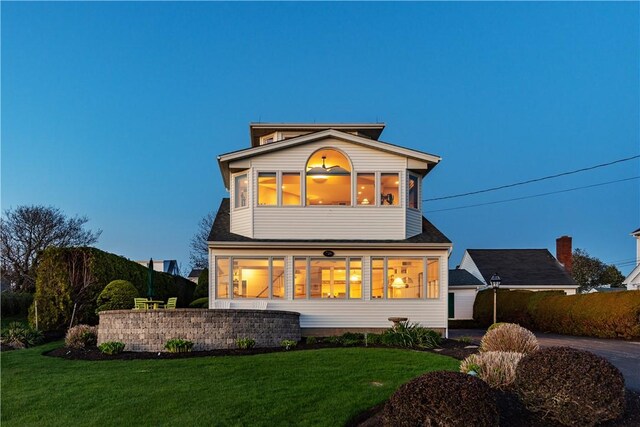 back of house with a lawn
