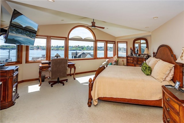 bedroom with baseboards, vaulted ceiling, and light colored carpet