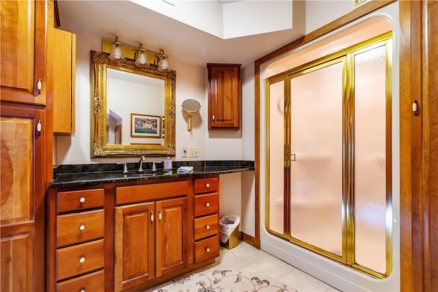 bathroom with tile patterned floors, a stall shower, and vanity