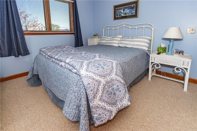 carpeted bedroom featuring baseboards