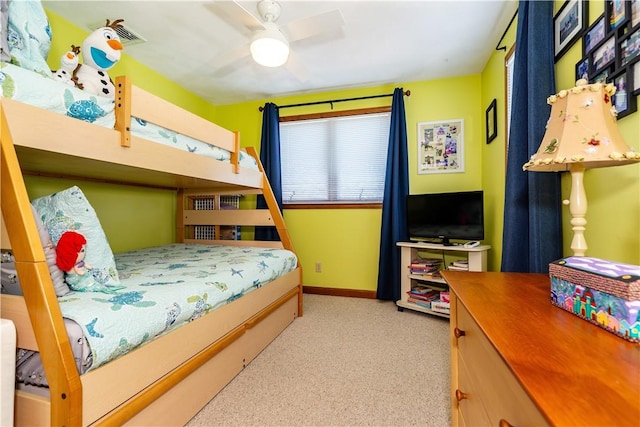 carpeted bedroom featuring baseboards and a ceiling fan