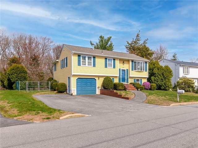 132 Elton Cir, Cranston, RI 02921 - split foyer home with aphalt driveway, fence, a garage, and a front lawn