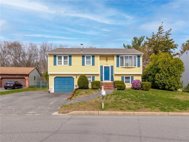 132 Elton Cir, Cranston, RI 02921 - bi-level home with a front lawn, aphalt driveway, a garage, and fence