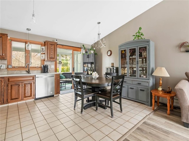132 Elton Cir, Cranston, RI 02921 - dining space with light tile patterned floors, lofted ceiling, and a notable chandelier