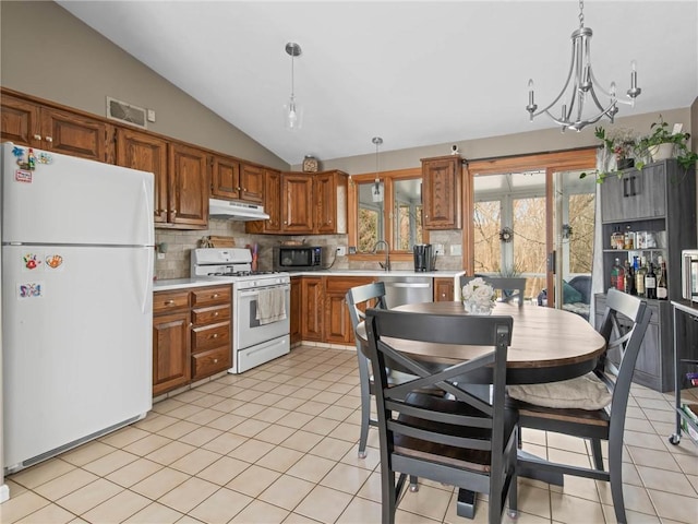 132 Elton Cir, Cranston, RI 02921 - kitchen featuring lofted ceiling, white appliances, pendant lighting, light countertops, and decorative backsplash