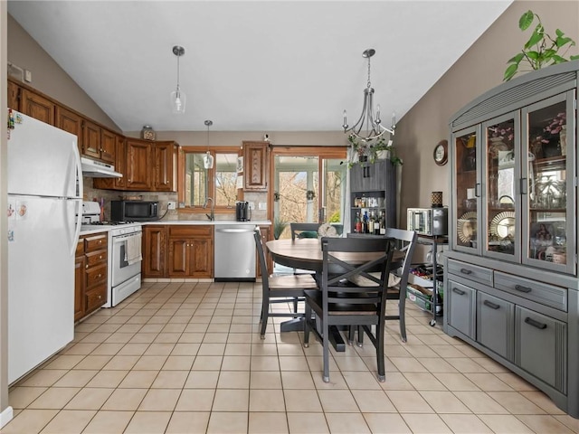 132 Elton Cir, Cranston, RI 02921 - kitchen featuring brown cabinets, white appliances, under cabinet range hood, light countertops, and vaulted ceiling
