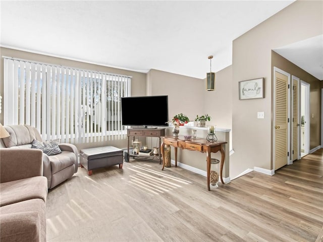 132 Elton Cir, Cranston, RI 02921 - living area with vaulted ceiling, wood finished floors, and baseboards