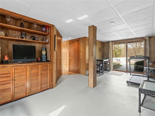 132 Elton Cir, Cranston, RI 02921 - living room featuring a drop ceiling, wood walls, and finished concrete flooring