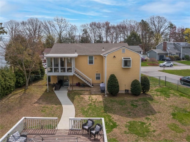 132 Elton Cir, Cranston, RI 02921 - rear view of property with a yard, roof with shingles, a sunroom, and a fenced backyard