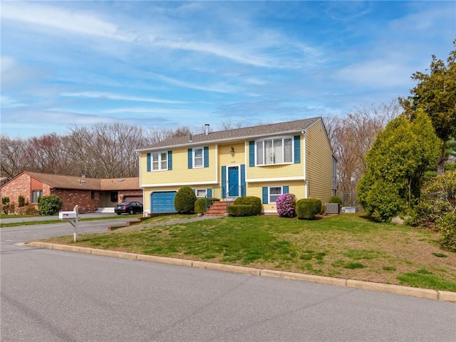 132 Elton Cir, Cranston, RI 02921 - raised ranch featuring a garage, a front yard, aphalt driveway, and central AC
