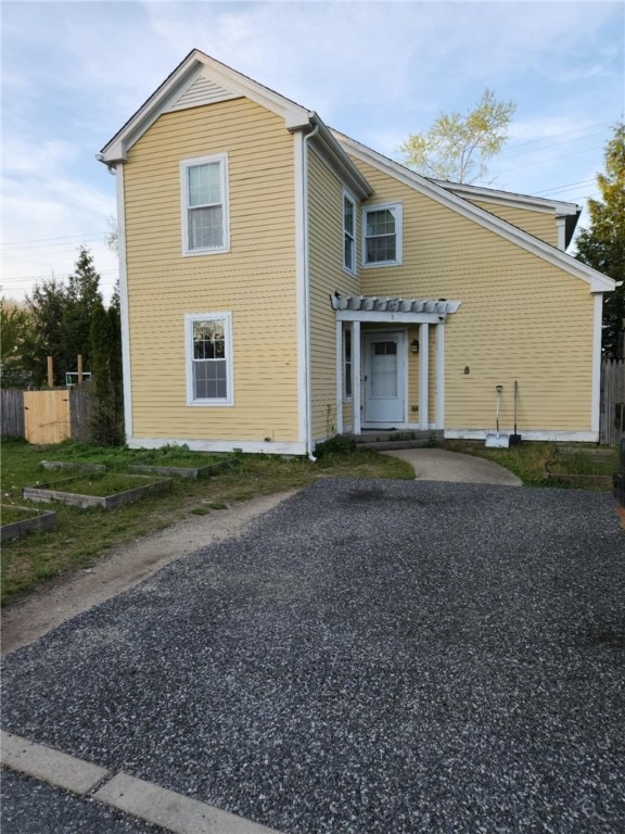 view of front of house featuring a pergola and fence