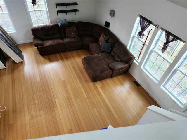 living room featuring visible vents, wood finished floors, and baseboards