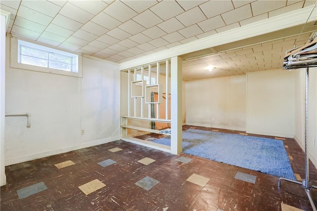 below grade area with tile patterned floors and baseboards