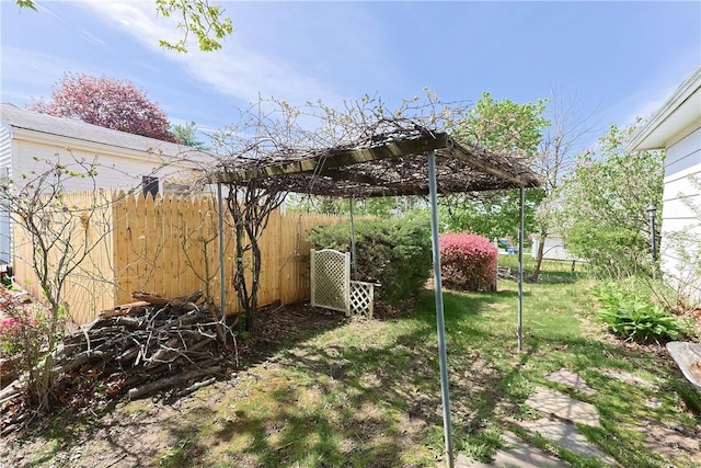 view of yard featuring a pergola and fence