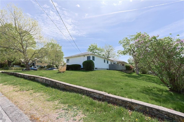 view of side of property with a lawn