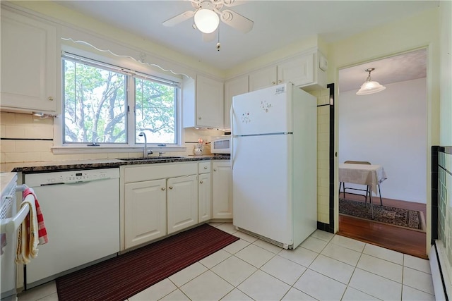 kitchen featuring a sink, white appliances, white cabinets, ceiling fan, and backsplash
