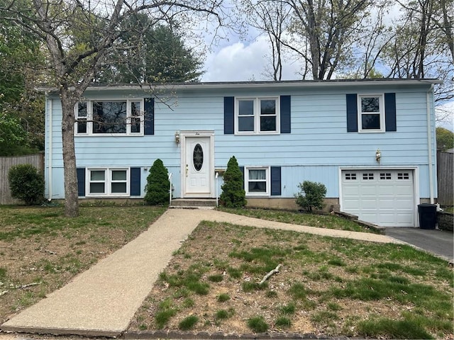10 Lawnwood Rd, Coventry, RI 02816 - raised ranch with fence, an attached garage, and driveway