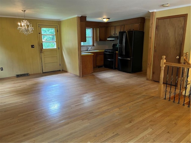 10 Lawnwood Rd, Coventry, RI 02816 - kitchen with black appliances, a chandelier, light wood-style floors, ornamental molding, and light countertops