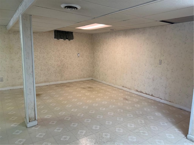 10 Lawnwood Rd, Coventry, RI 02816 - finished below grade area featuring a paneled ceiling, light flooring, and wallpapered walls