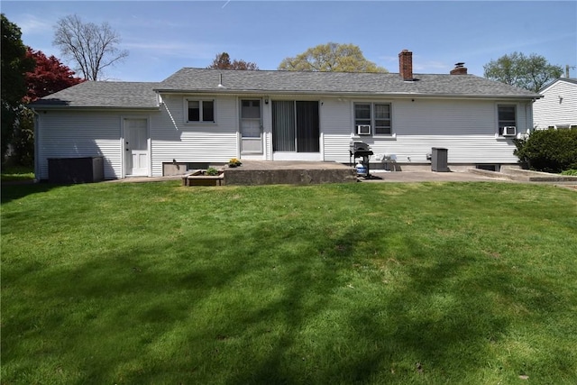 76 Oregon Ave, North Providence, RI 02911 - back of property with a lawn, a patio area, cooling unit, and a chimney