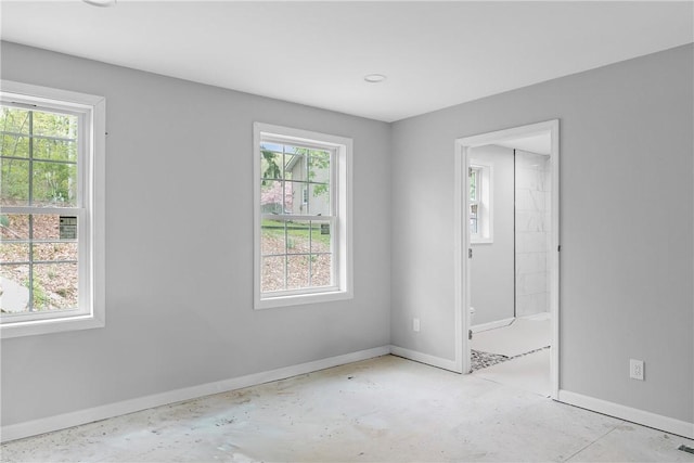 empty room with baseboards and a healthy amount of sunlight