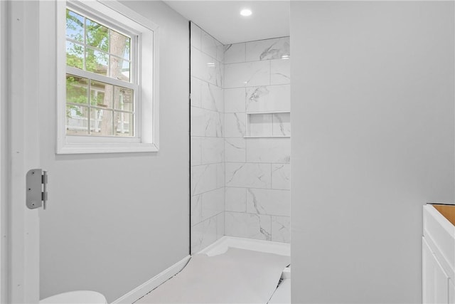 full bath featuring baseboards, a shower, and recessed lighting