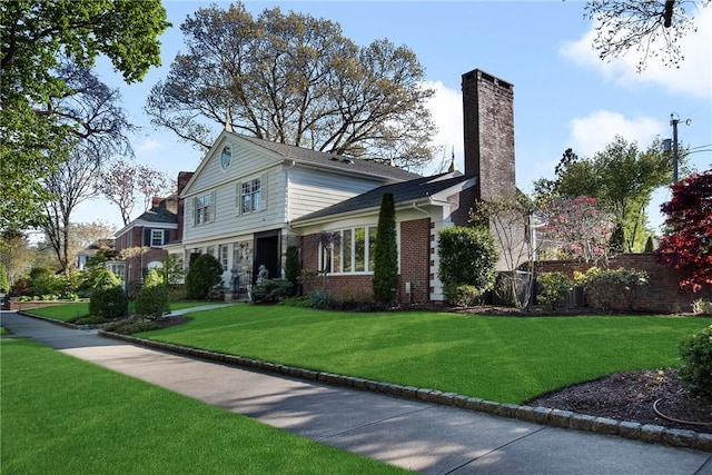 540 Blackstone Blvd, Providence, RI 02906 - view of front of property with a chimney, brick siding, a front lawn, and fence