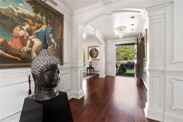 540 Blackstone Blvd, Providence, RI 02906 - entrance foyer featuring a decorative wall, ornate columns, dark wood finished floors, a baseboard radiator, and arched walkways