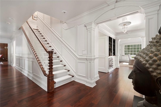 540 Blackstone Blvd, Providence, RI 02906 - staircase with ornamental molding, hardwood / wood-style floors, a decorative wall, and ornate columns